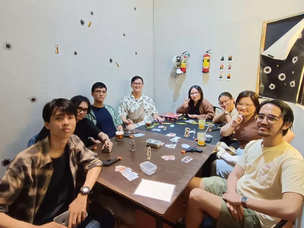 Group of friends playing board games and laughing around a table in a cozy indoor game night setting
